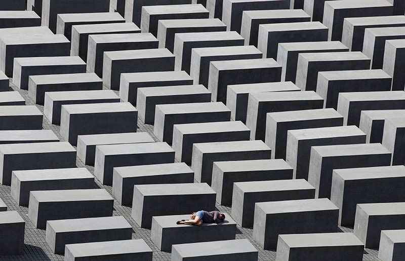A girl rests on a concrete column of the Holocaust memorial in Berlin, Germany, June 17, 2011. (Reuters Photo)