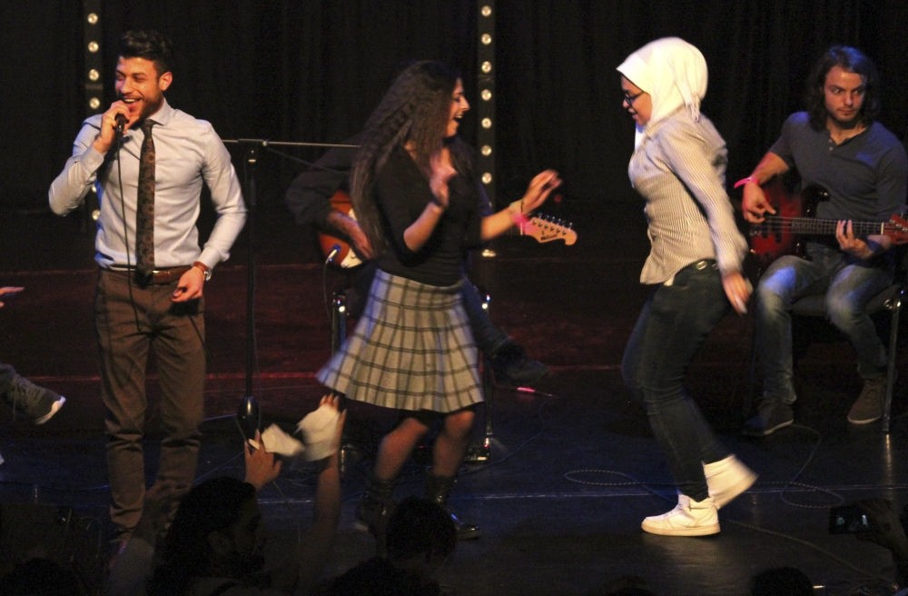 A group of women dance on stage during the performance by the Syrian band Musiqana at the u201cRefugees in concertu201d event in Berlin.