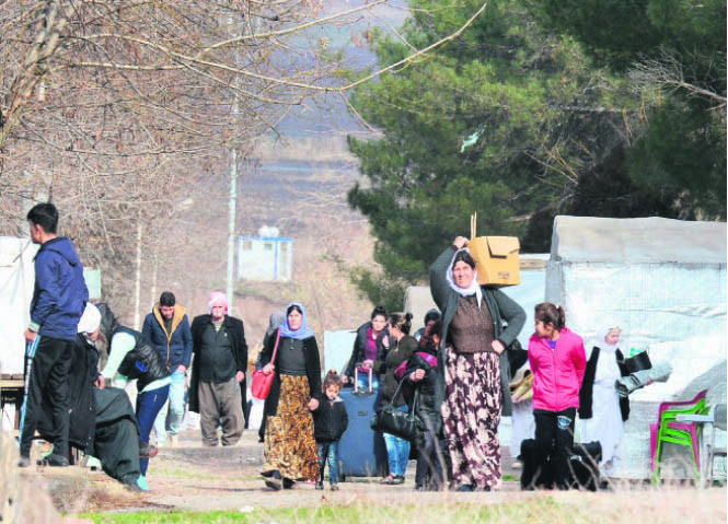 Refugees, terrorism & sharing of water resources are just a few of many issues of discussion between neighbors Iraq & Turkey. This picture shows Yazidi refugees from Iraq carry their belongings on Jan. 3 in Diyarbaku0131r as they change their camp.