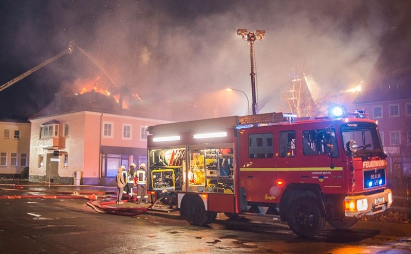 This file photo taken on February 21, 2016 shows fire fighters trying to extinguish a fire at a former hotel that was under reconstruction to become a home for asylum seekers on February 21, 2016 (AFP Photo)