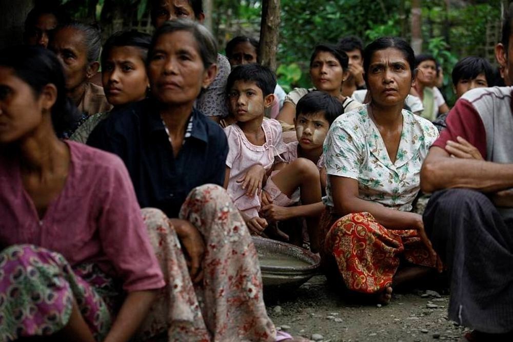 Muslims sit in a temporary refugee camp after losing their homes during recent violence in Thapyuchai village, outside of Thandwe in the Rakhine state.