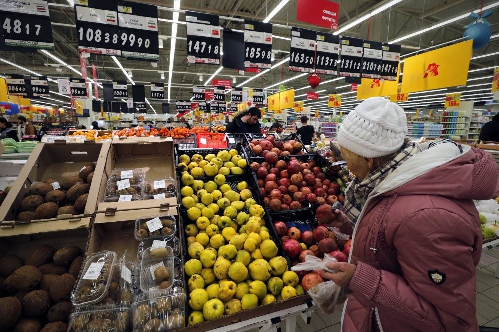 A Russian woman chooses fruits imported from Turkey at a supermarket.