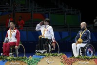 From left, Guo Xingyuan of China, Abdullah u00d6ztu00fcrk of Turkey and Maxime Thomas of France pose during the medal ceremony.