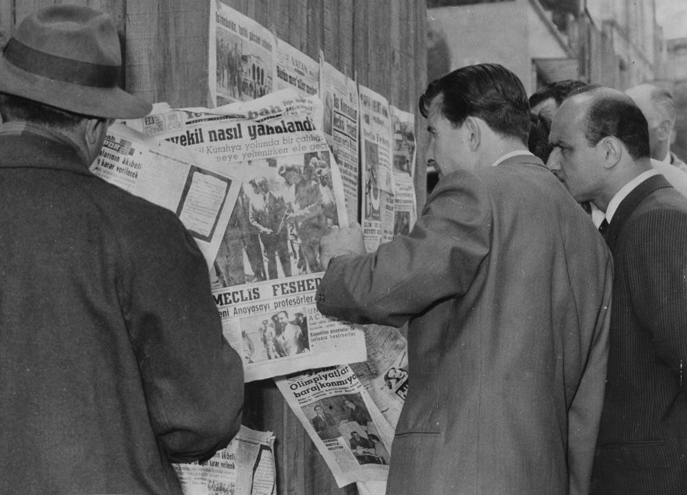 Citizens at a newsstand read of the arrest of Prime Minister Menderes after the coup in 1960.