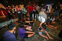 Injured people are helped by emergency rescue workers outside a station after an explosion on a passenger train in Taipei, Taiwan, Thursday, July 7, 2016. (AP Photo)