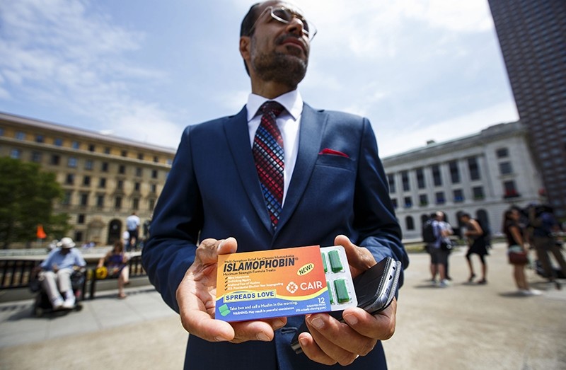 Nihad Awad, the National Executive Director of Council on American-Islamic Relations, holds a pack of chewing gum the group made called 'Islamophobin'. (EPA Photo)