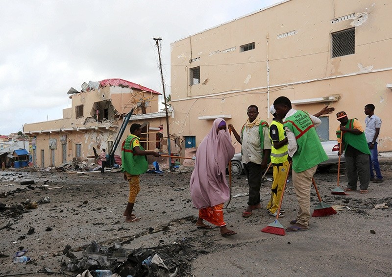 Workers clear debris at the scene of an explosion at the gate of Siyad hotel after Friday night's attack in Somalia's capital Mogadishu, July 11, 2015. (Reuters Photo)