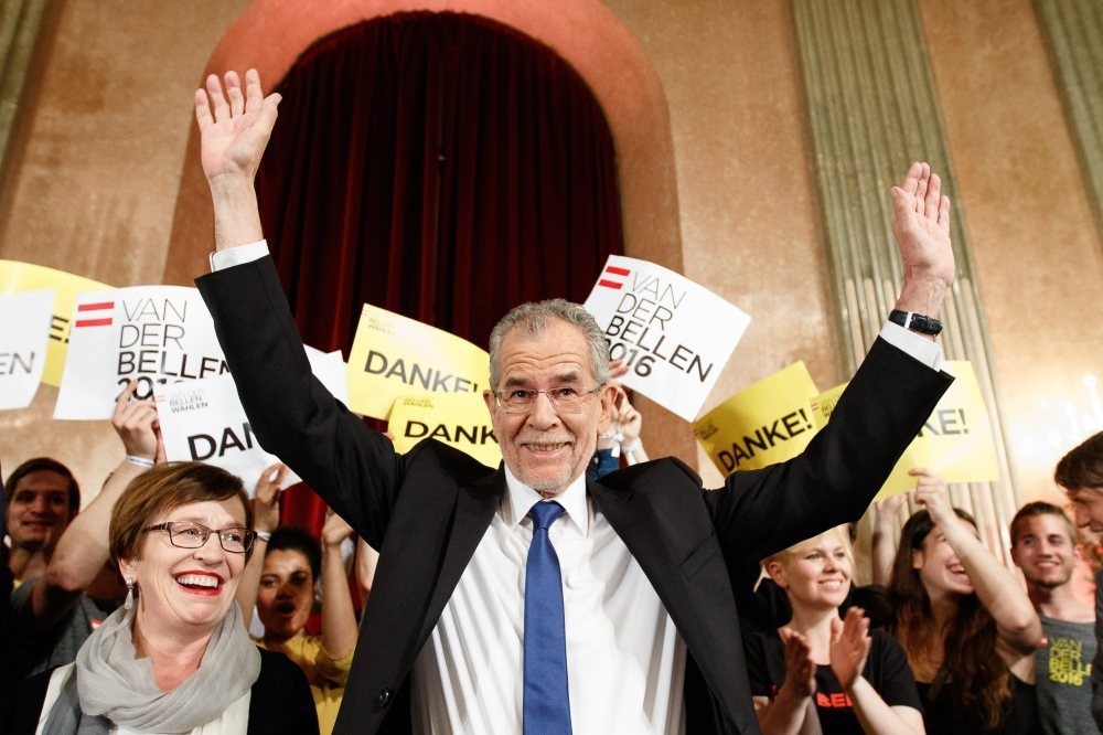 Austria's new president-elect, Alexander Van der Bellen (C), waves to supporters at the Palais Auersperg in Vienna, Austria, on May 22.