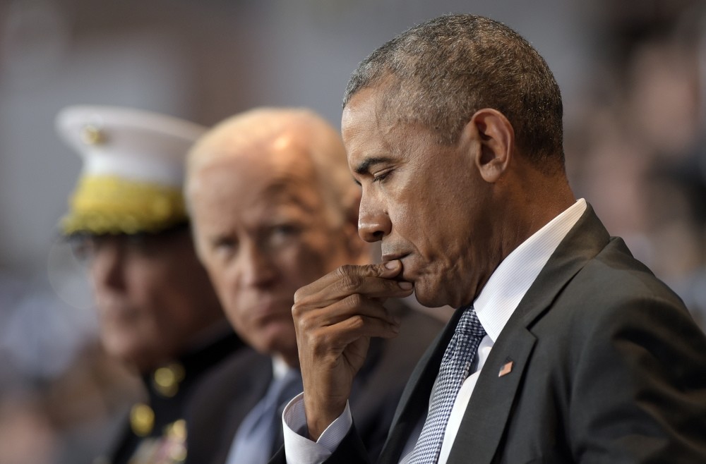 President Barack Obama listens as Defense Secretary Ash Carter speaks during an Armed Forces Full Honor Farewell Review for the President at Conmy Hall. (AP Photo)