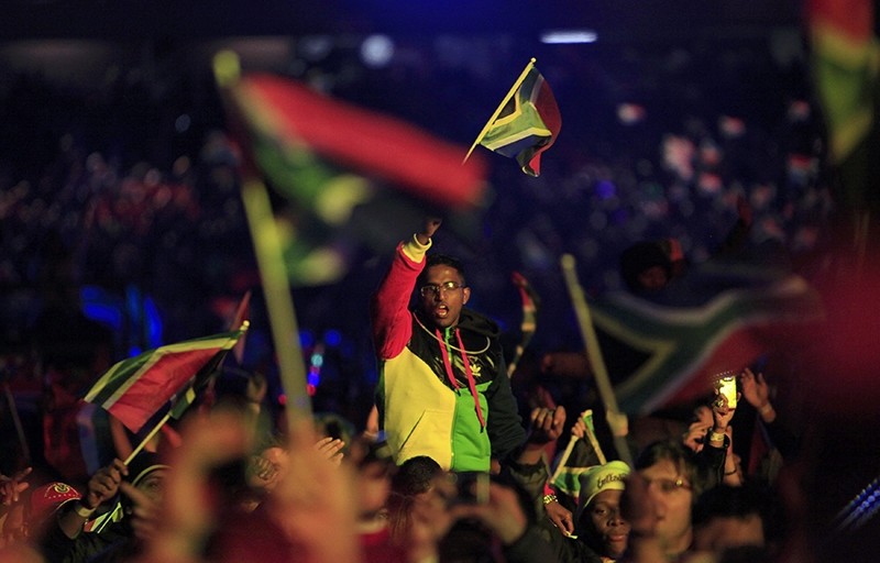 A fan waves a South African flag during the opening concert for the 2010 World Cup at the Orlando Stadium in Soweto, Johannesburg June 10, 2010. (REUTERS Photo)