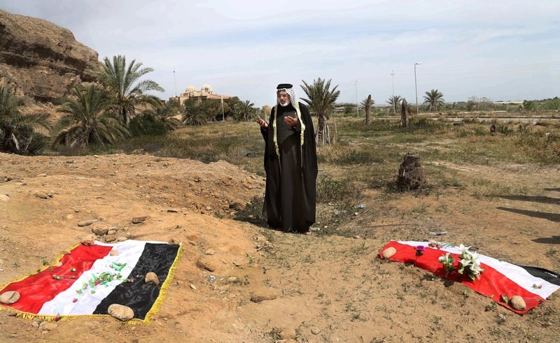 In this April 3, 2015 file photo, an Iraqi man prays for his slain relative, at the site of a mass grave, believed to contain the bodies of Iraqi soldiers killed by Daesh  AP Photo