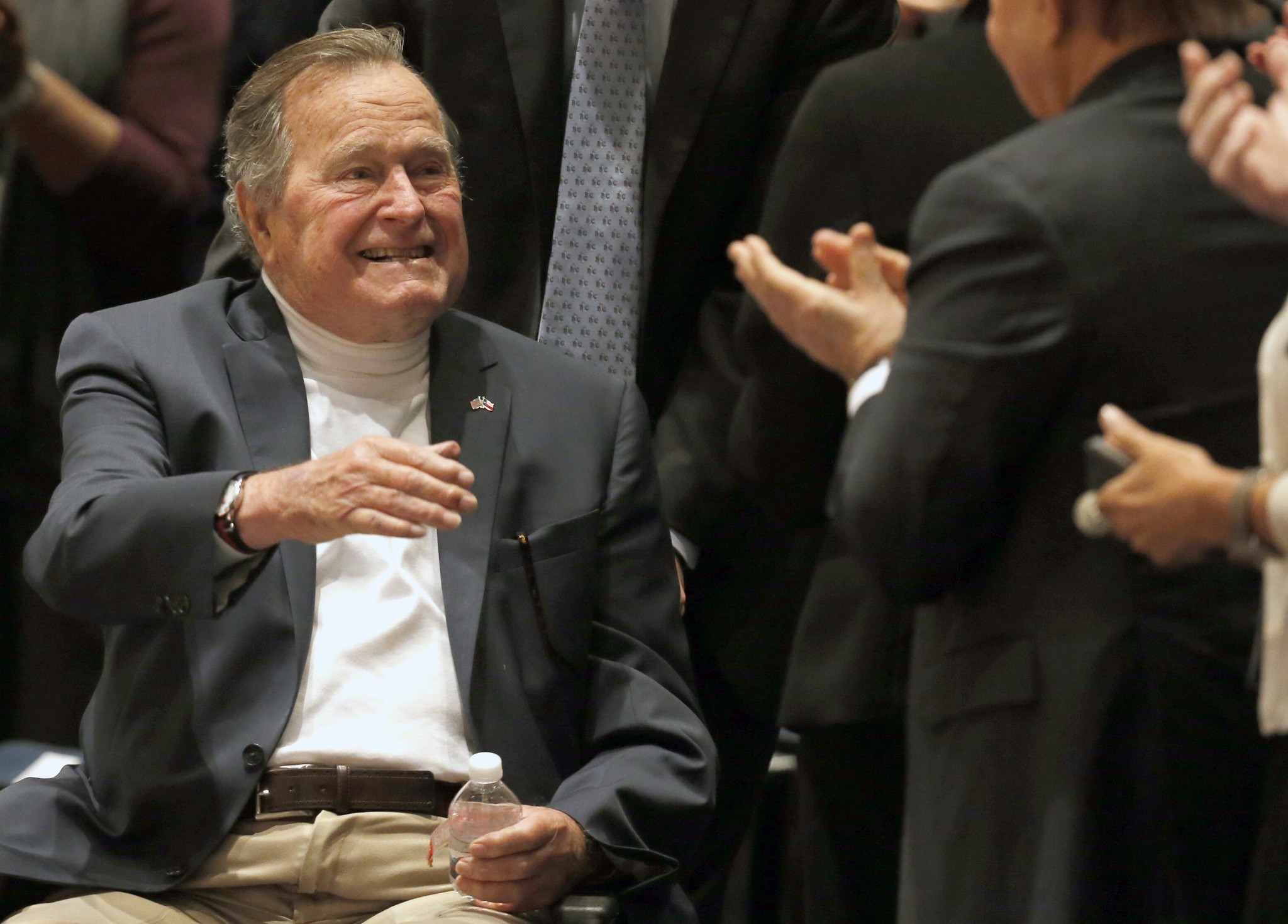 Former President George H.W. Bush acknowledges the crowd at his presidential library before his son former President George W. Bush discusses his new book. (AP Photo)