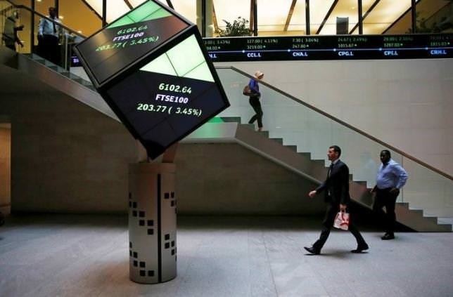 People walk through the lobby of the London Stock Exchange in London, Britain August 25, 2015.  REUTERS