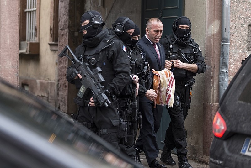 Former PM of Kosovo Ramush Haradinaj, second right, leaves the court escorted by hooded police officers in Colmar, eastern France on Jan. 12, 2017. (AP Photo)