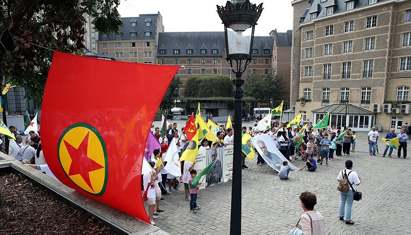 Sympathizers carrying terrorist group's banners and posters of its jailed leader Abdullah u00d6calan celebrate the anniversary of PKK's 1st armed attack in 1984 killing 2 Turkish soldiers, in Spanjeplein Square near Brussels, on Dec. 15, 2016. (AA Photo)