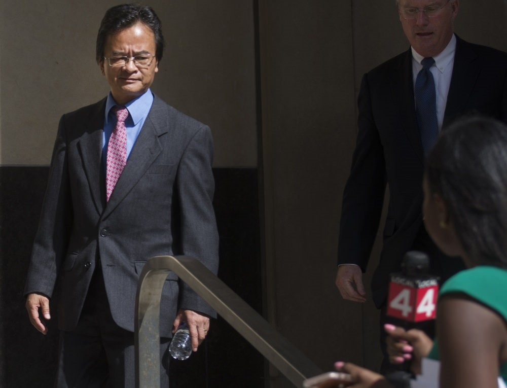 Volkswagen engineer James Robert Liang, left, leaves court in Detroit, after pleading guilty to one count of conspiracy in the companyu2019s emissions cheating scandal, Liang has agreed to cooperate in the widening criminal investigation.