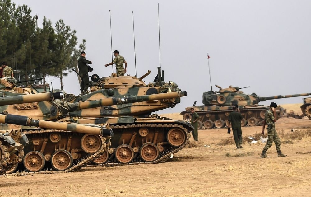 Turkish soldiers standing by tanks at the Karkamu0131u015f district of Turkey's southeastern province of Gaziantep on its border with Syria, Aug. 25.