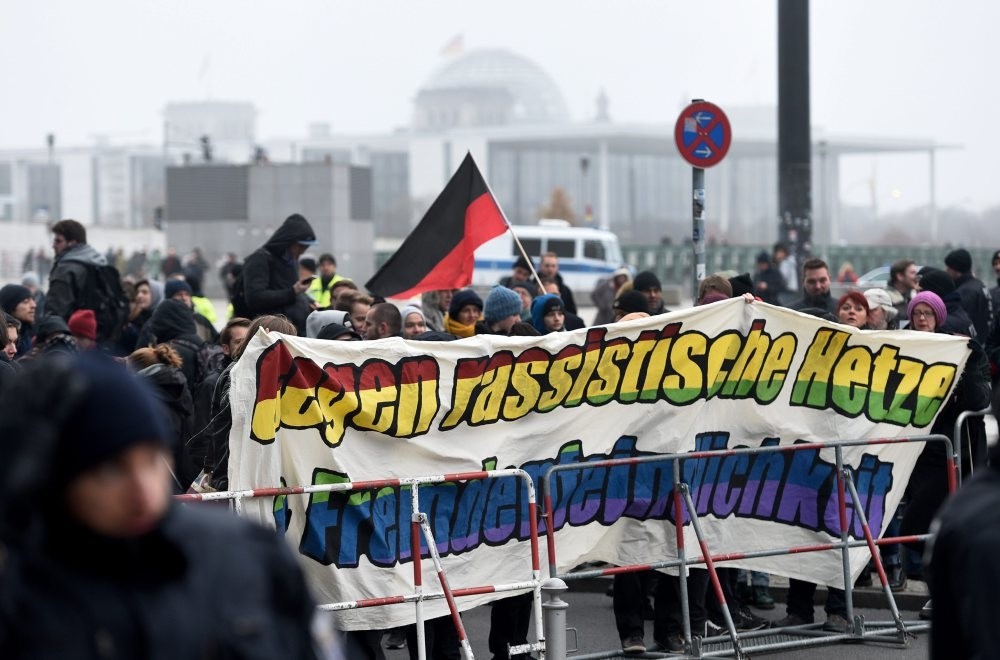 Counter demonstrators holding a banner reading: 'Against racist agitation and xenophobia' during a protest by the Berlin offshoot of the anti-Islam Pegida movement 'Baergida' in Berlin, Nov. 26, 2016. 