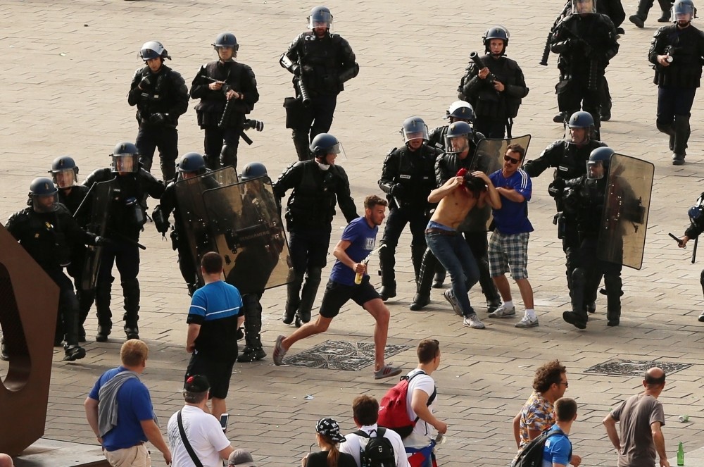 French riot police moving in to detain Russian football fans after violence broke out between supporters ahead of the England vs Russia Euro 2016 football match, in Marseille on June 11, 2016. 