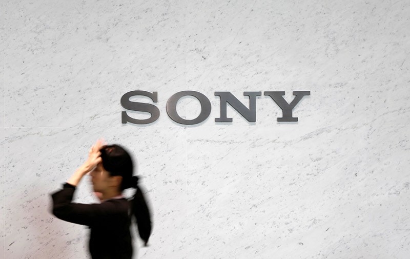 A reception staff walks under a logo of Sony Corp at its headquarters in Tokyo February 4, 2015. (Reuters Photo)