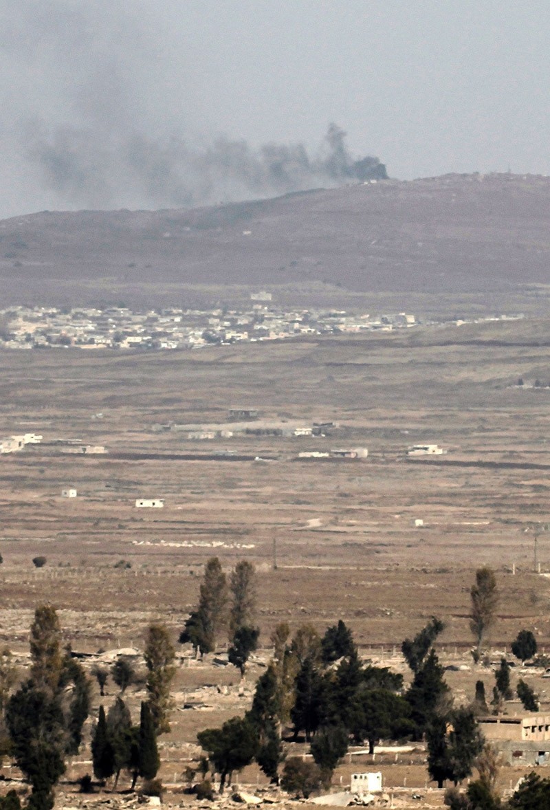 A picture taken from the Israeli-annexed Golan Heights shows smoke rising from a Syrian army position on November 9, 2016. (Photo AFP)