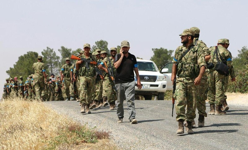 Turkmen fighters of Sultan Murat Brigade seen advancing to Keklijah village some five kilometers west of northern Syrian town of Jarablus. (AA Photo)