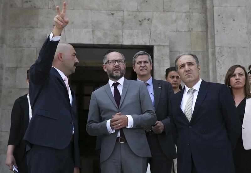 Chairman of Parliament's Human Rights Investigation Commission Mustafa Yenerou011flu (R) gives tour of the bombed Turkish Parliament to German Minister of State for Europe Michael Roth (M) along with his delegation on August 26, 2016.  AA Photo