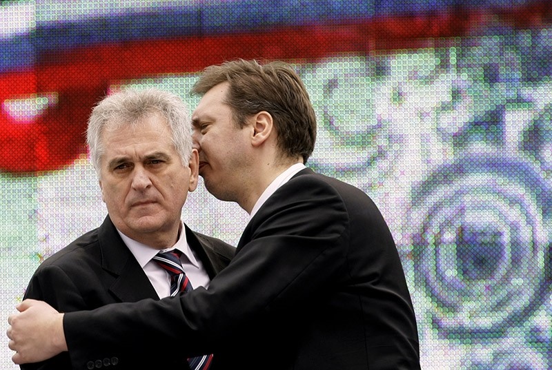 Serbian Prime Minister Aleksandar Vucic, right, speaks with Serbian President Tomislav Nikolic during a protest rally in Belgrade, Serbia. (AP file photo)