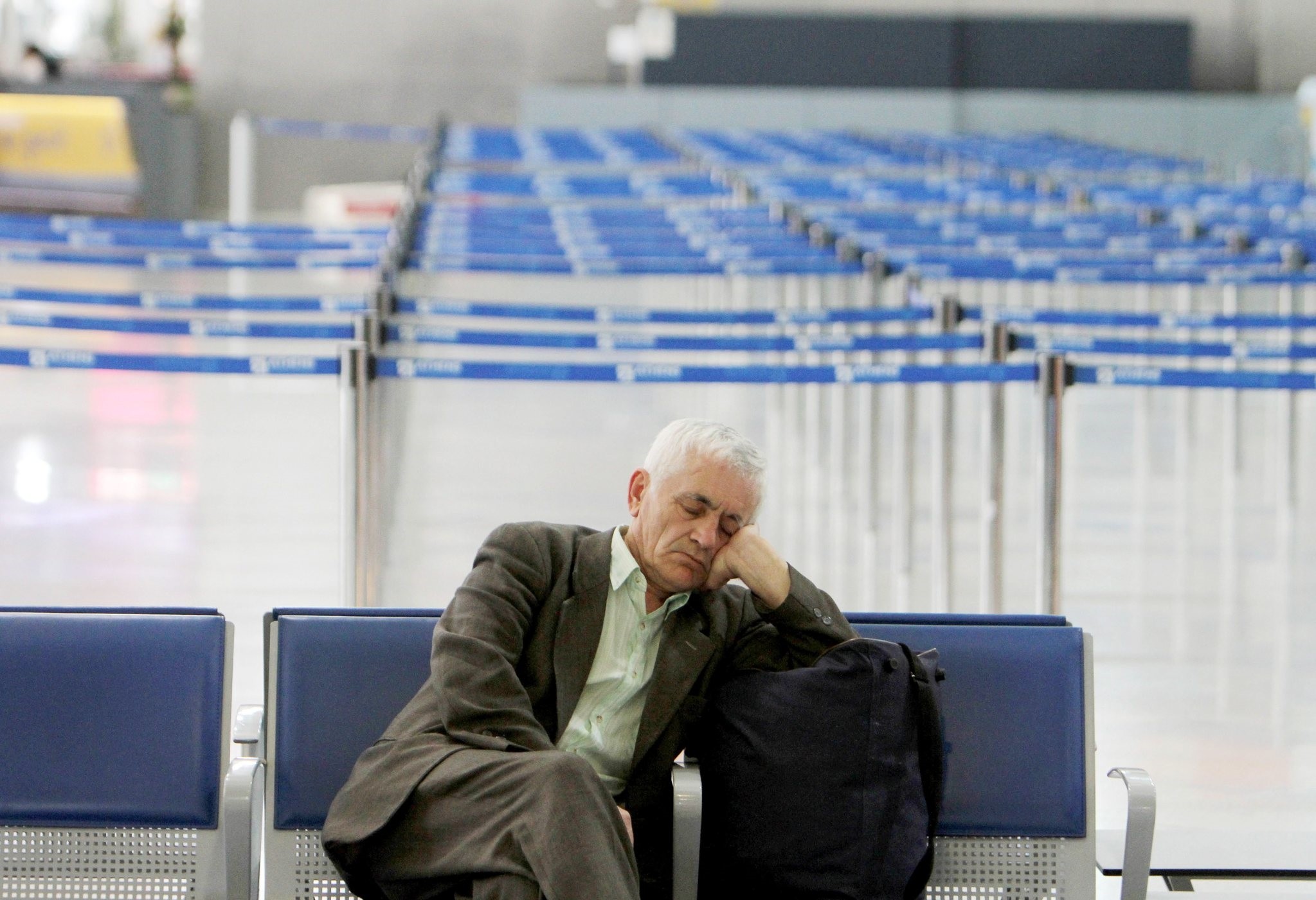 A passenger sleeps during a strike at the Athens International Airport Eleftherios Venizelos in Spata on Wednesday, Feb. 24, 2010. (AP Photo)