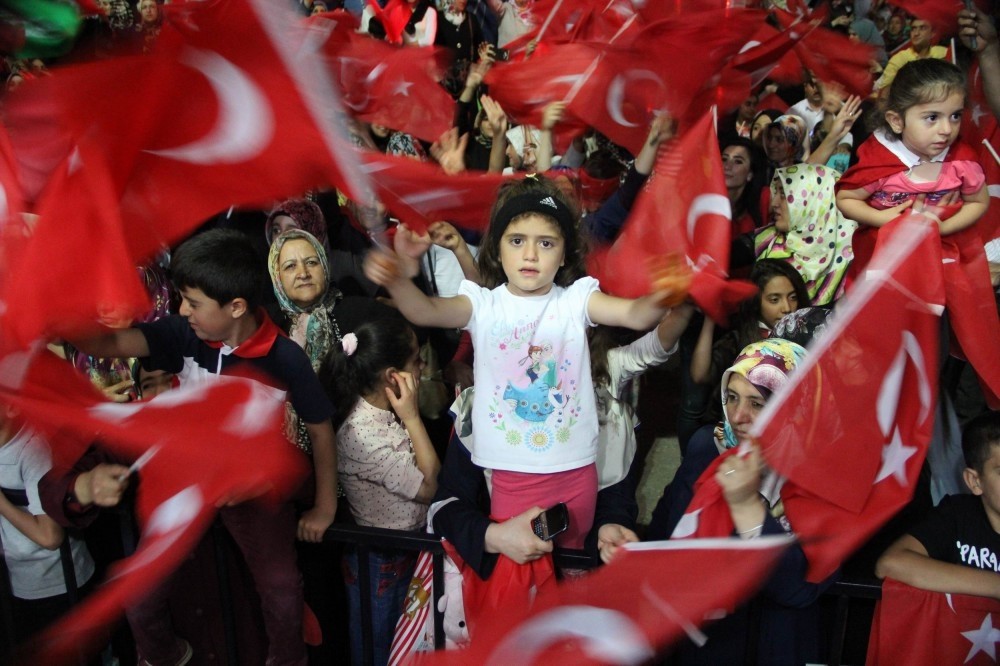 A girl wavesa flag at a democracy rally in Van. Democracy rallies occured after calls by the president and prime minister.
