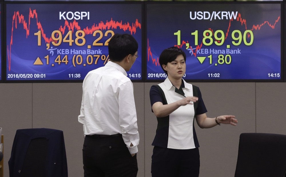 Currency traders work at the foreign exchange dealing room of the KEB Hana Bank headquarters in Seoul, South Korea.