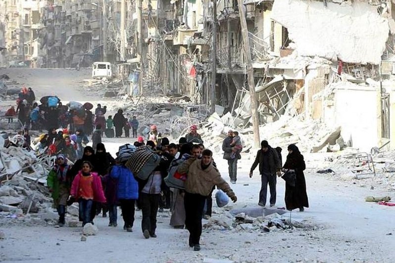 Displaced Syrian families leave the neighborhoods where the fighting occurs in eastern Aleppo, Syria, Nov. 29.
