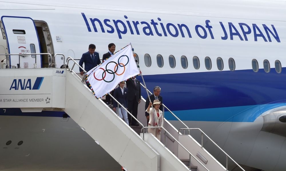 Tokyo Governor Yuriko Koike waves the Olympic flag upon arrival at Haneda international airport in Tokyo. The Olympic flag arrived in Tokyo, host of the next 2020 Summer Games.
