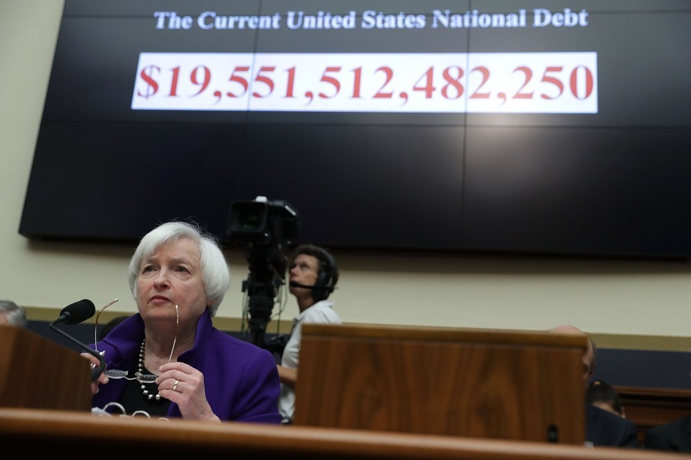 As the number of the current U.S. national debt is shown on a screen, Federal Reserve Board Chair Janet Yellen testifies during a hearing before the House Financial Services Committee on Capitol Hill in Washington, DC.