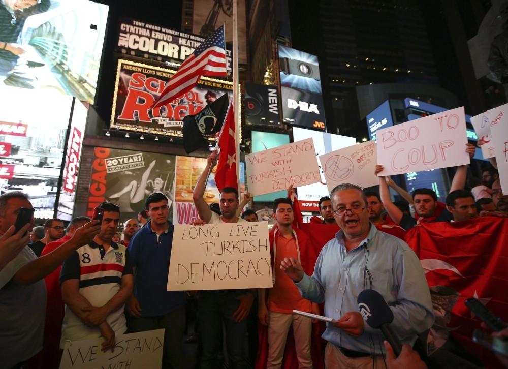 Turkish community activist Ibrahim Kurtuluu015f speaks in front of crowd protesting the attempted coup, in Times Square, New York. 