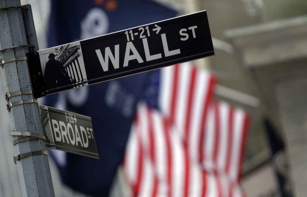 File photo, shows a Wall Street sign adjacent to the New York Stock Exchange. Key U.S. jobs data to be announced later in the week could help determine how soon the U.S. Federal Reserve raises interest rates.