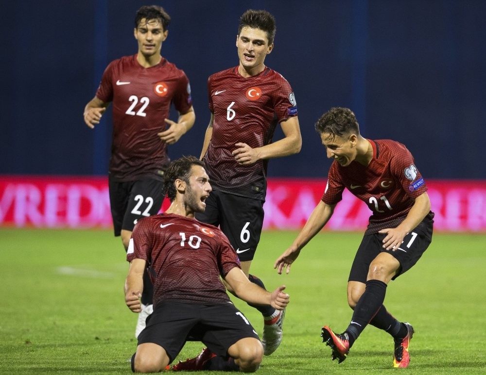 Hakan u00c7alhanou011flu (front L) celebrates with his teammates after scoring the 1-1 equalizer during the FIFA World Cup 2018 qualifying match between Croatia and Turkey in Zagreb.