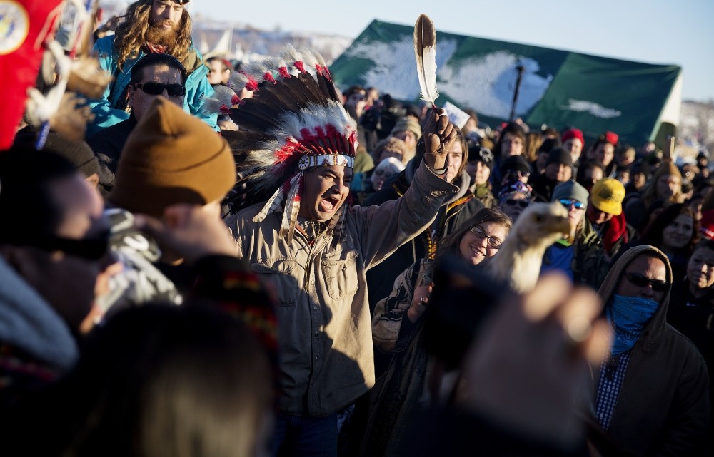 A crowd gathers in celebration at the Oceti Sakowin camp after it was announced that the U.S. Army Corps of Engineers won't grant easement for the Dakota Access oil pipeline in Cannon Ball.