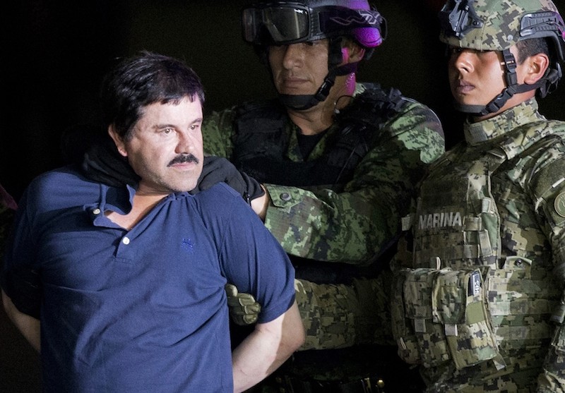 Joaquin ,El Chapo, Guzman is made to face the press as he is escorted to a helicopter by Mexican soldiers at a federal hangar in Mexico City. (AP Archive Photo)