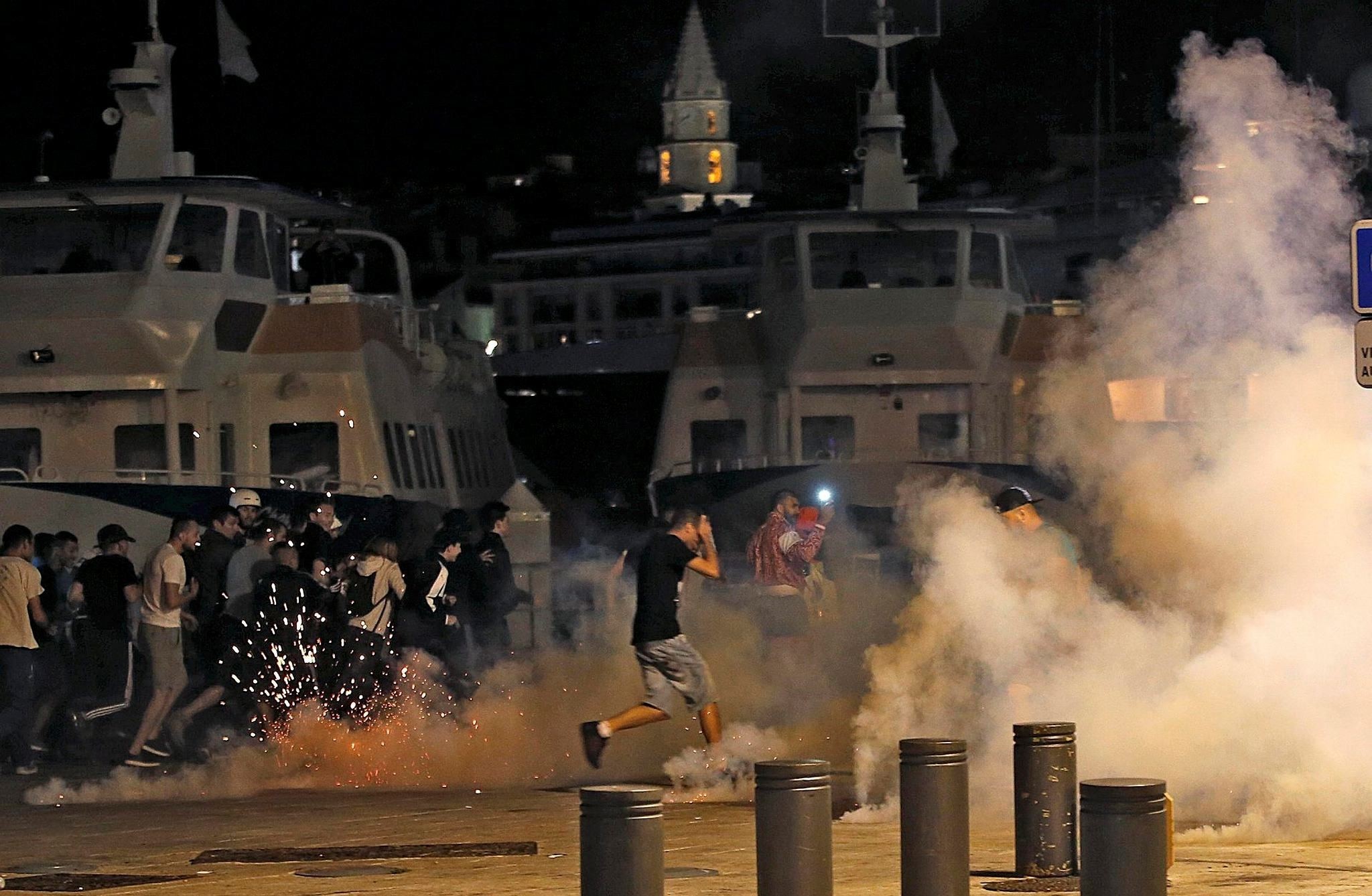  Police disperse revellers at the old port of Marseille after the England v Russia - Group B match. (Reuters Photo)