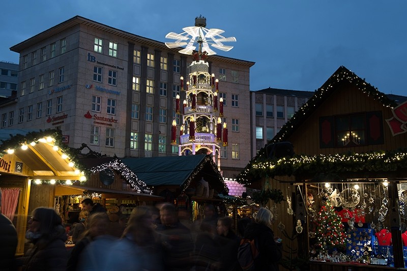 Visitors walk across the Christmas market in Kassel, Germany, Monday Dec. 12, 2016. (AP Photo)
