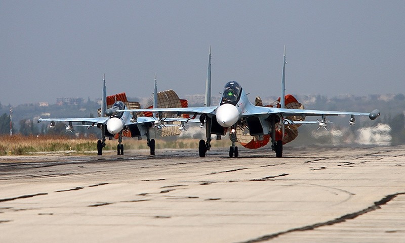  picture taken on October 3, 2015 shows Russian Sukhoi SU-30 SM jet fighters landing on a runway at the Hmeimim airbase in the Syrian province of Latakia. (AFP Photo)