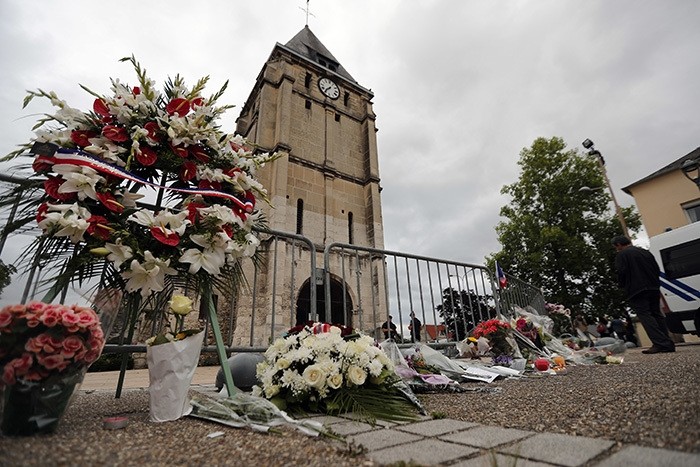  wreath of flowers from Muslim of France Associations is placed with flowers next to the church where an hostage taking left a priest dead the day before in Saint-Etienne-du-Rouvray, Normandy, France, Wednesday, July 27, 2016. (AP Photo)