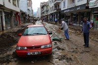 Locals and workers cleared the mud that covered the towns following the floods.