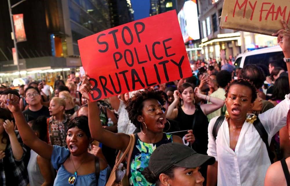 Activists protest in Times Square in New York City in response to the recent fatal shootings of two black men by police.