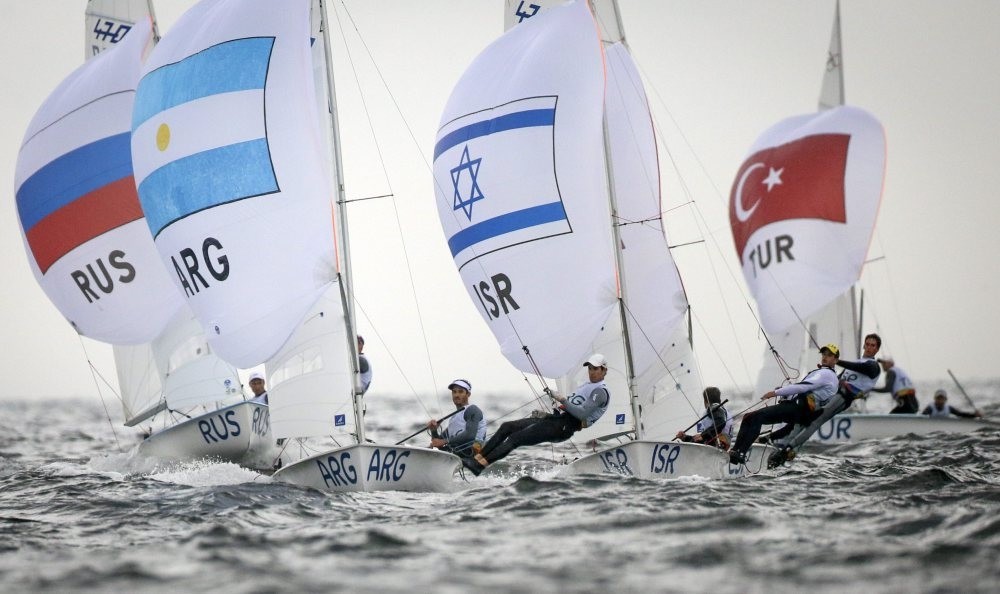 Argentinian 470 Laser class sailors Lucas Calabrese and Juan de la Fuente sail in front of Russian Israel and Turkish crews during the Rio 2016 Olympic Games Sailing events in Guanabara Bay, Rio de Janeiro.