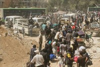 People gather before being evacuated from the besieged Damascus suburb of Daraya. (Sanaa via Reuters)