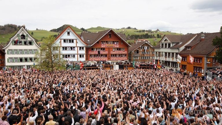 People raise their hands to vote during the annual Landsgemeinde meeting at a square in Appenzell, Switzerland, April 29, 2012 (Reuters Photo)