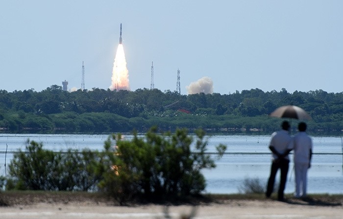Bystanders watch as Indian Space Research Organisation's (ISRO) satellite CARTOSAT-2, along with 20 other satellites (AFP Photo)