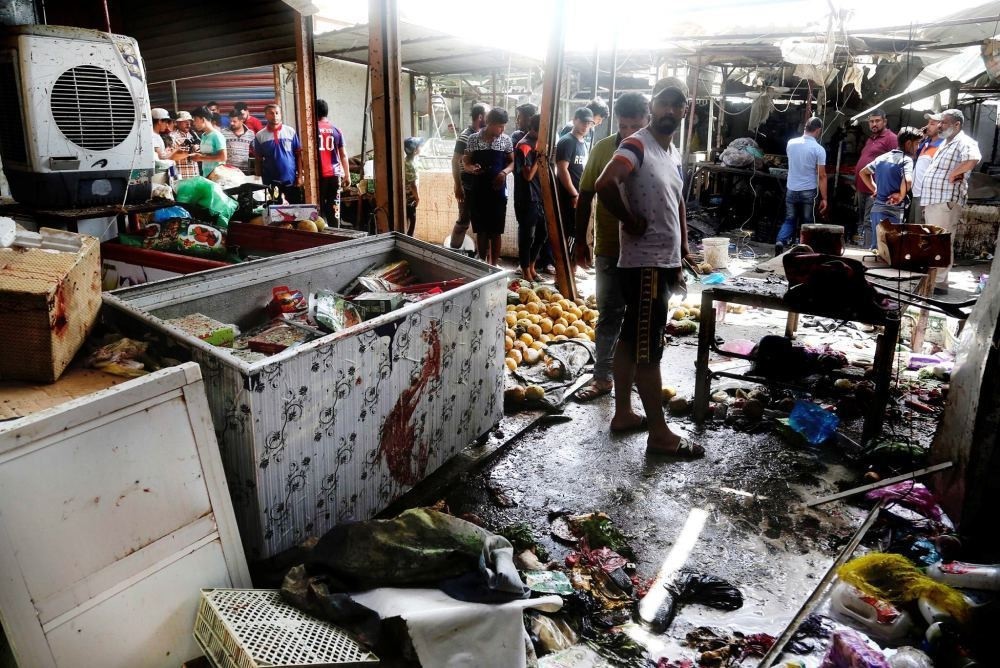Iraqis inspect a market after a suicide bombing claimed by DAESH hit a crowded area in Baghdad.